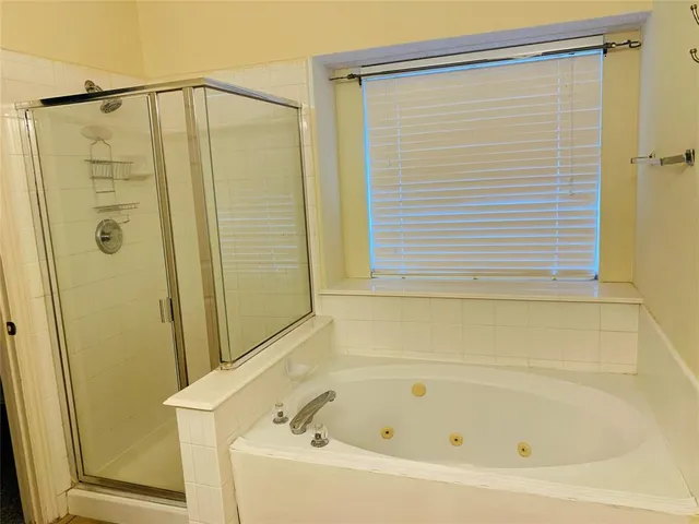 a bathroom with a shower and a bathtub