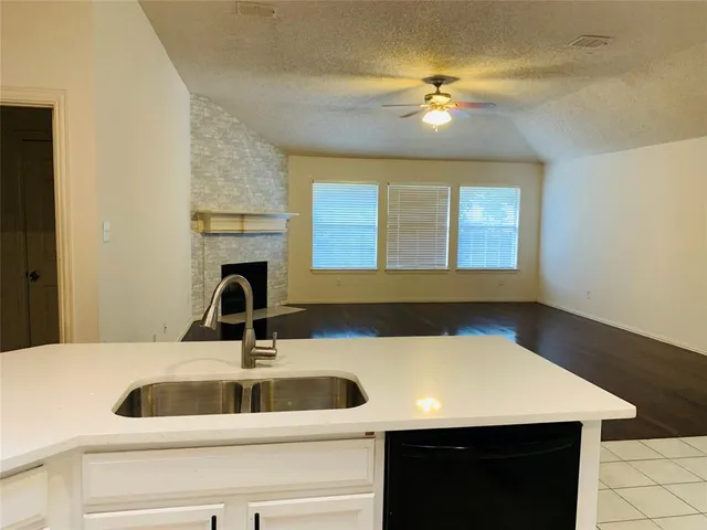 an empty room with a window and a chandelier
