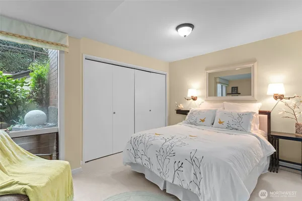 a bedroom with a bed and glass windows
