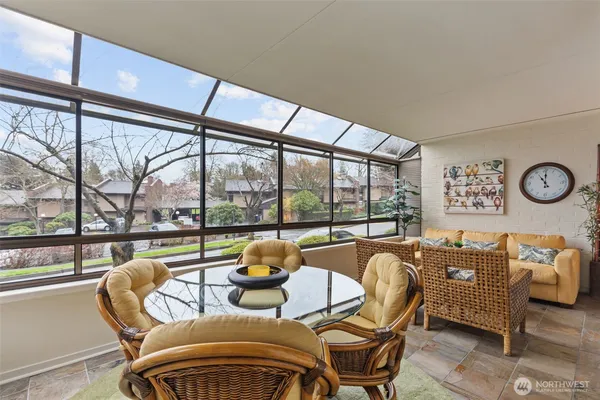a living room with furniture and a floor to ceiling window