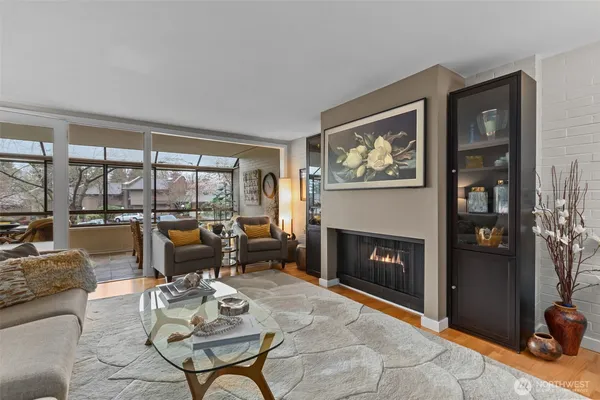 a living room with furniture large window and a fireplace
