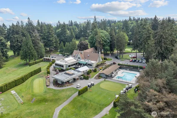 an aerial view of residential house with outdoor space and trees