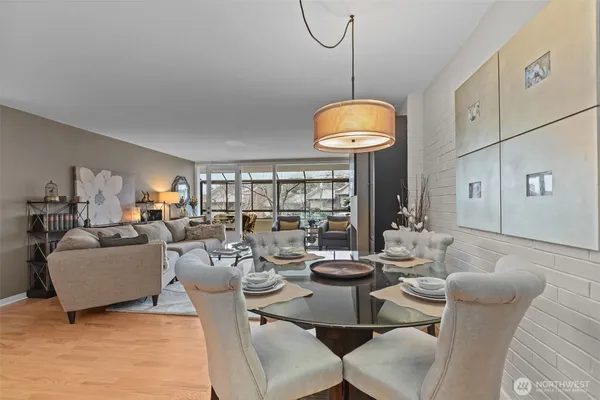 a living room with furniture a chandelier and a large window