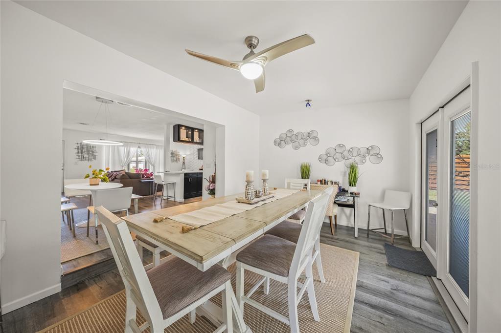 2427 Tulip Street Sarasota, FL 34239 - Photo 14 of 39 a view of a dining room with furniture and wooden floor