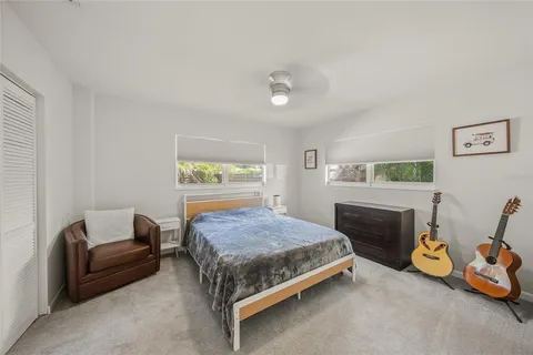 a bedroom with a bed and a couch