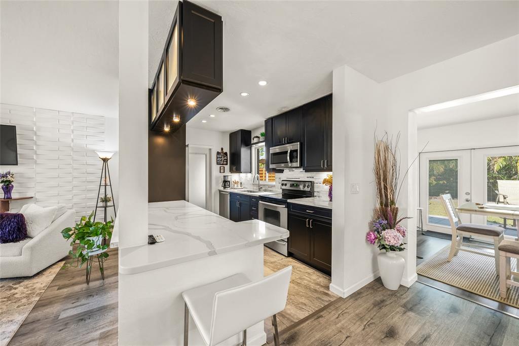 2427 Tulip Street Sarasota, FL 34239 - Photo 7 of 39 a kitchen with stainless steel appliances kitchen island granite countertop a refrigerator and a stove top oven