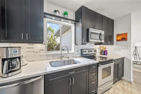 a kitchen with a sink stove and microwave