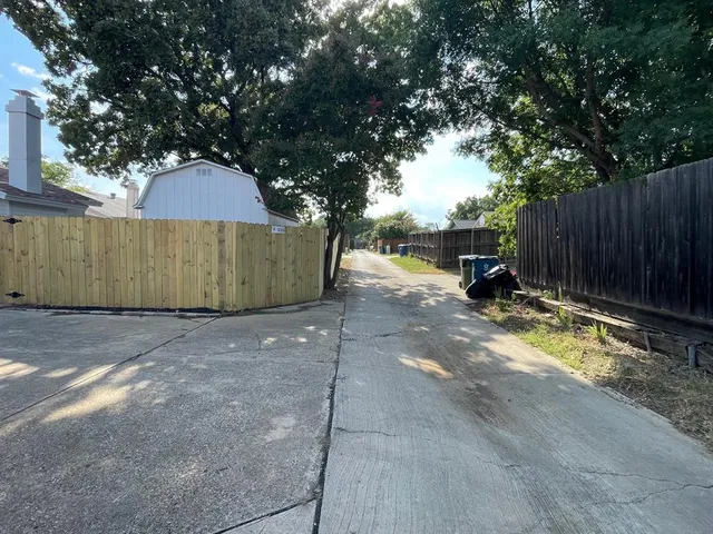 a view of a house with wooden fence