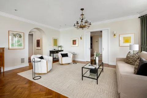 a living room with furniture or couch and a chandelier
