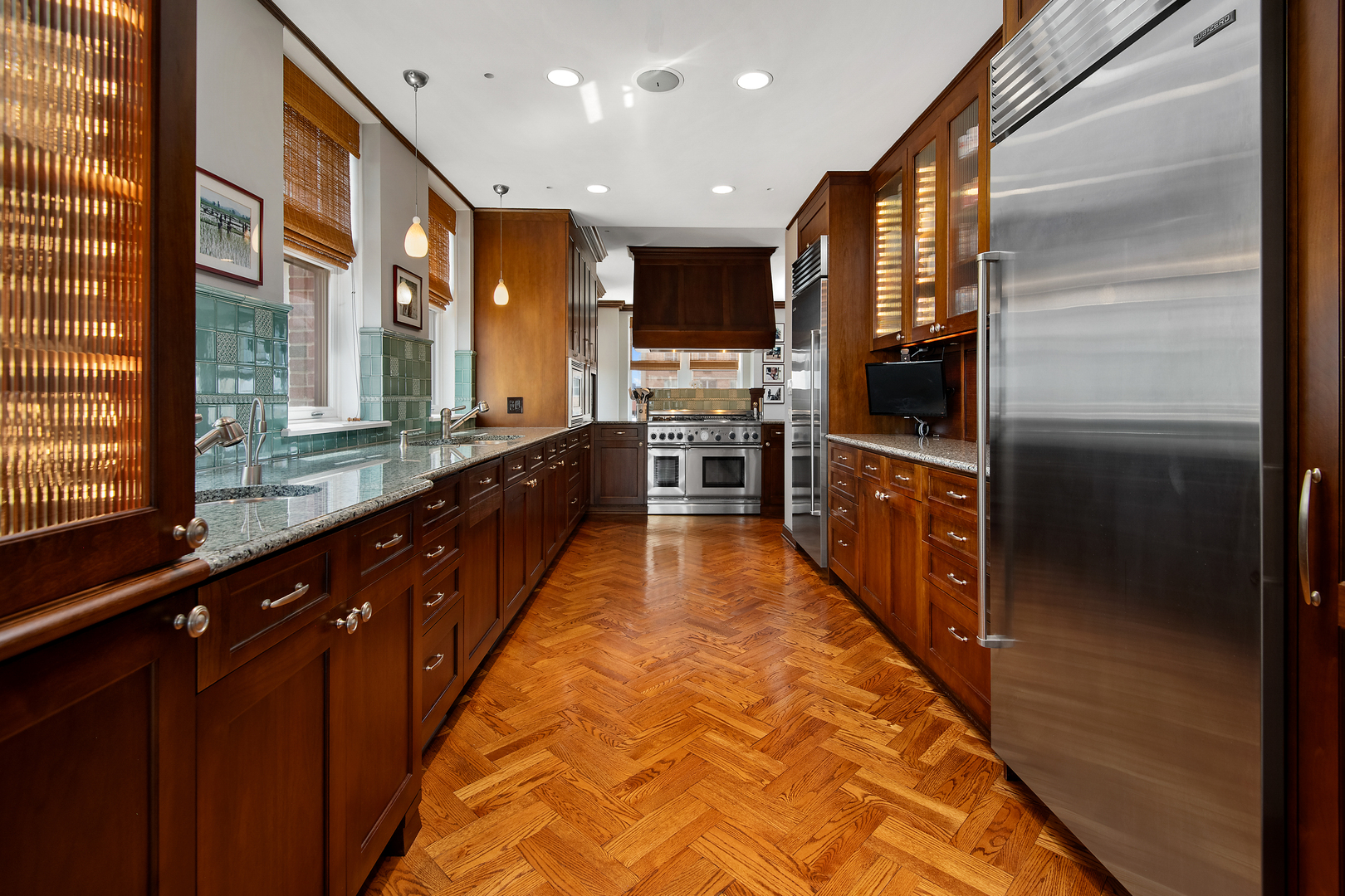 421 West Melrose Street, Unit 18BC Chicago, IL 60657 - Photo 8 of 29 a large kitchen with stainless steel appliances kitchen island granite countertop a large counter top space and a large window