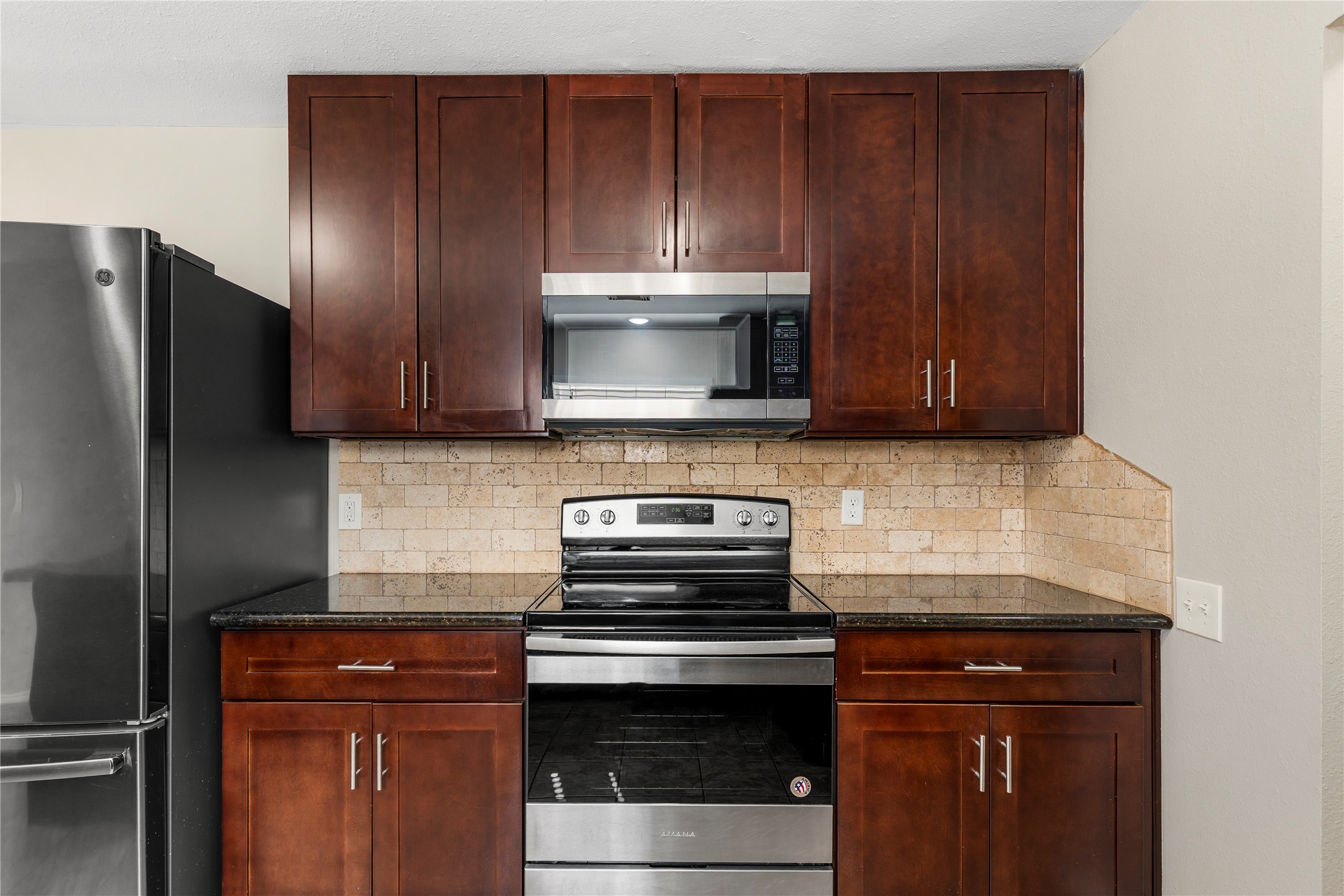 2007 Fernspray Lane Houston, TX 77084 - Photo 15 of 34 a kitchen with granite countertop wooden cabinets and stainless steel appliances