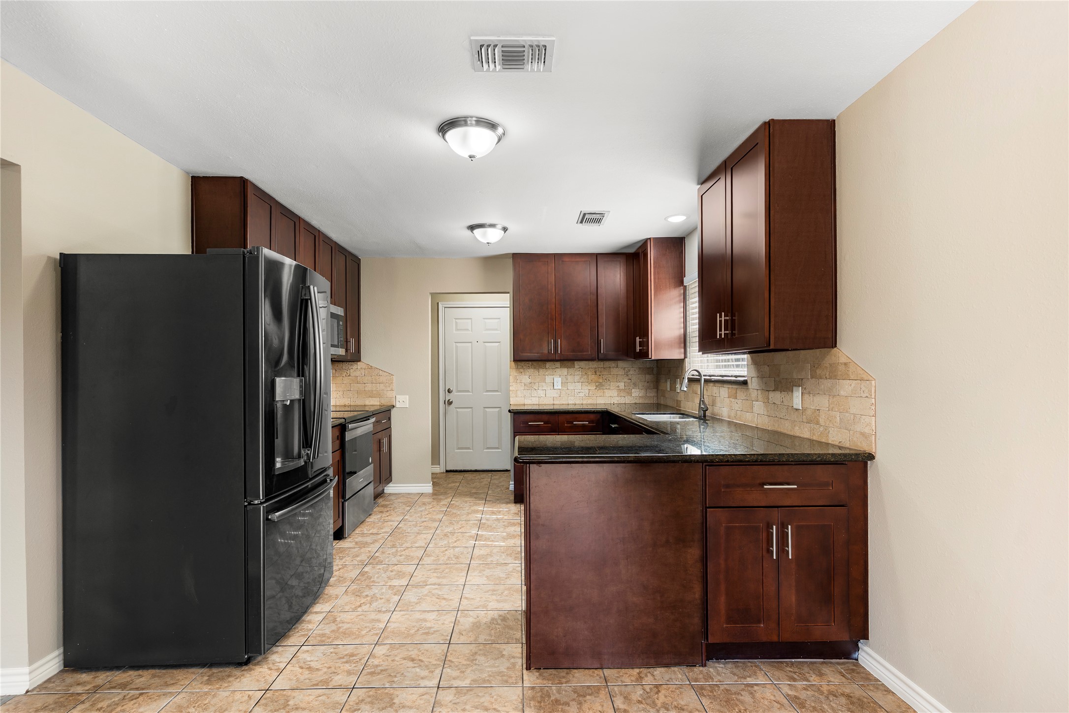 2007 Fernspray Lane Houston, TX 77084 - Photo 16 of 34 a kitchen with stainless steel appliances granite countertop a refrigerator and a stove top oven