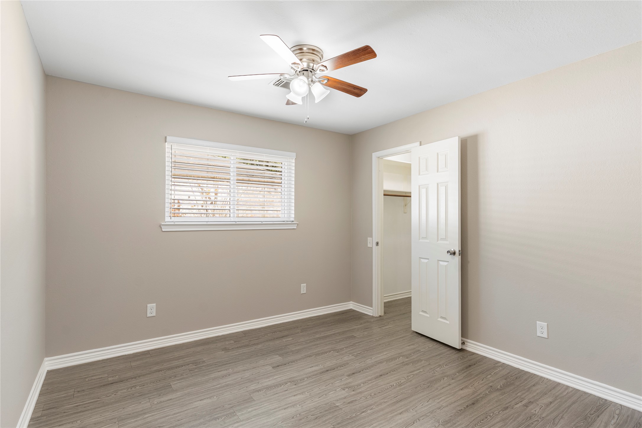2007 Fernspray Lane Houston, TX 77084 - Photo 23 of 34 an empty room with wooden floor and ceiling fan