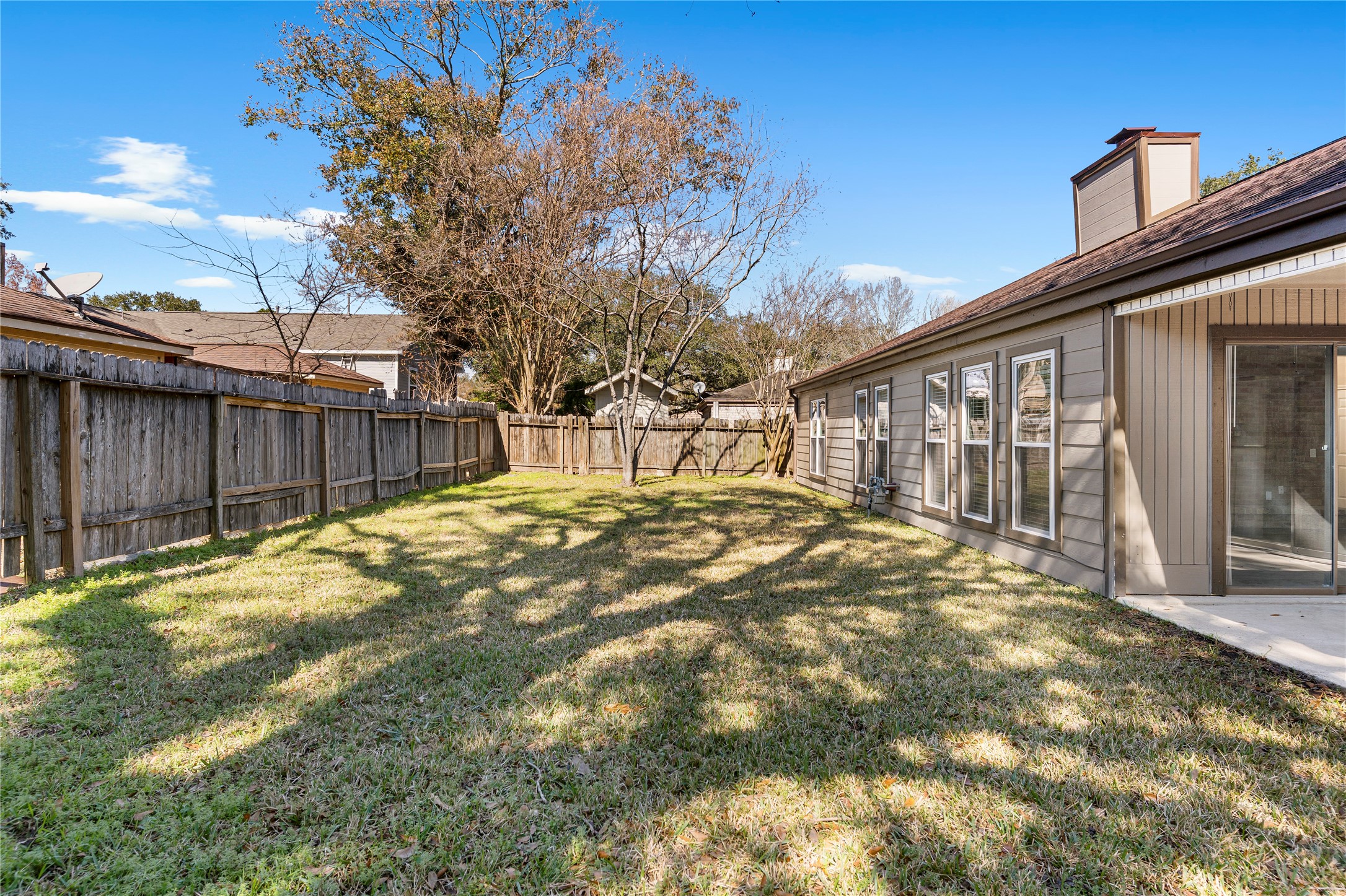 2007 Fernspray Lane Houston, TX 77084 - Photo 29 of 34 a view of backyard with wooden fence and large trees