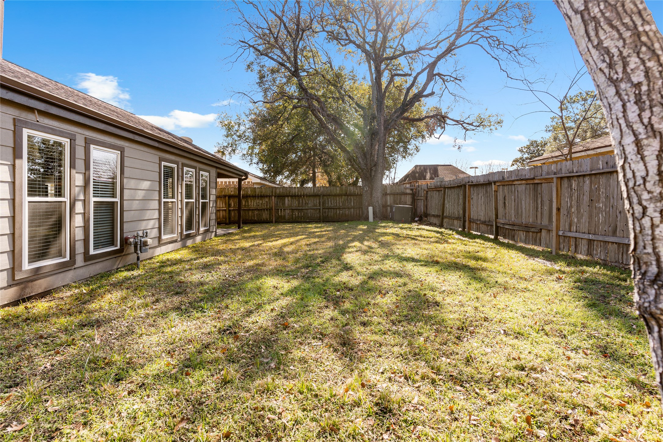 2007 Fernspray Lane Houston, TX 77084 - Photo 33 of 34 a view of a house with a large tree and wooden fence