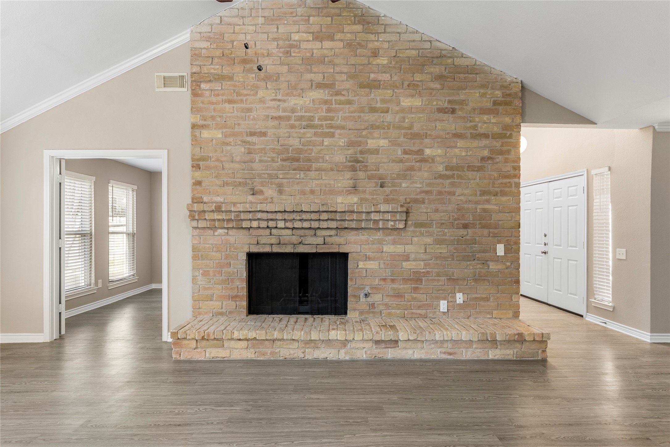 2007 Fernspray Lane Houston, TX 77084 - Photo 4 of 34 a view of a livingroom with wooden floor and a fireplace