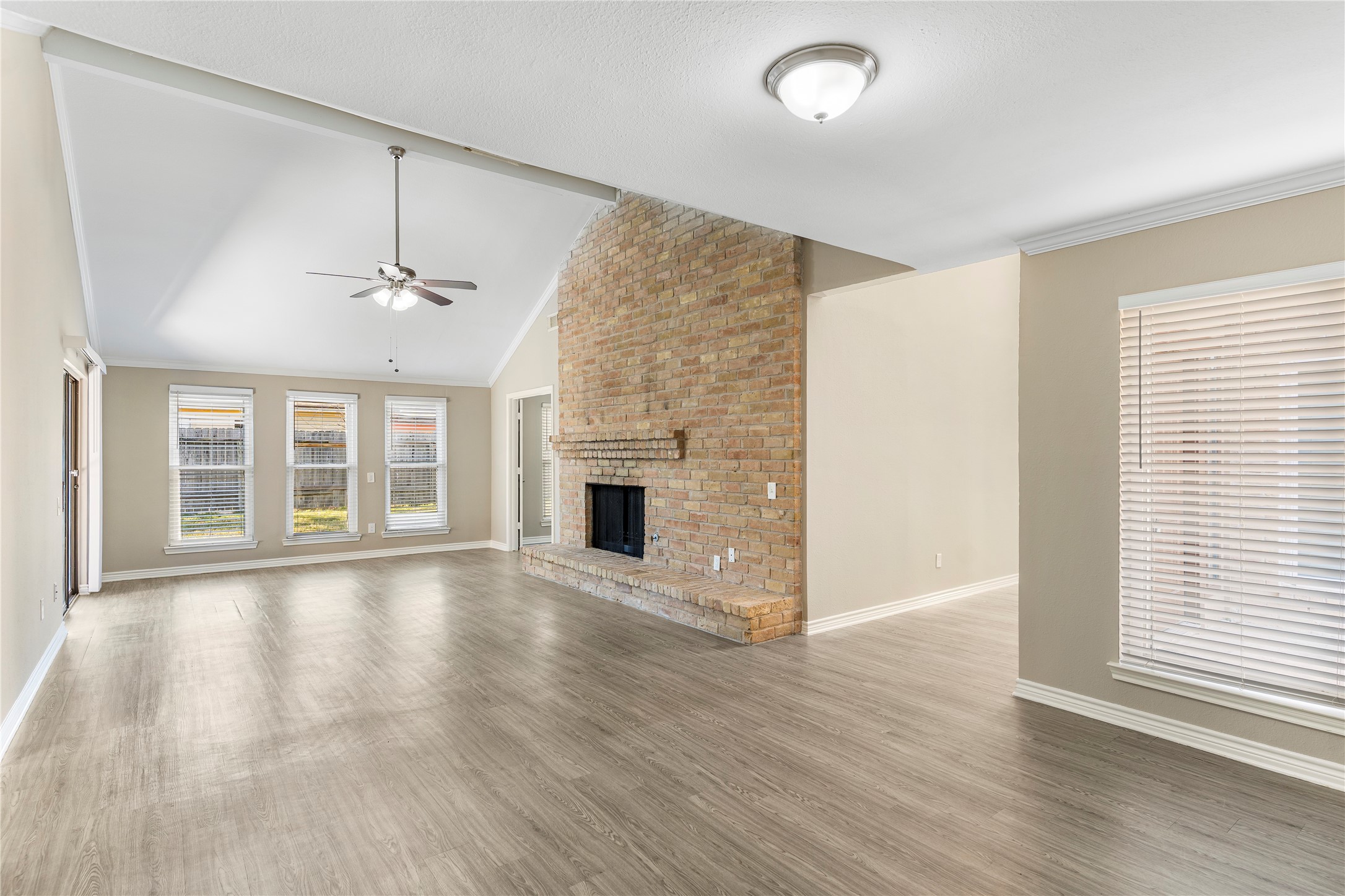 2007 Fernspray Lane Houston, TX 77084 - Photo 5 of 34 an empty room with wooden floor chandelier and windows