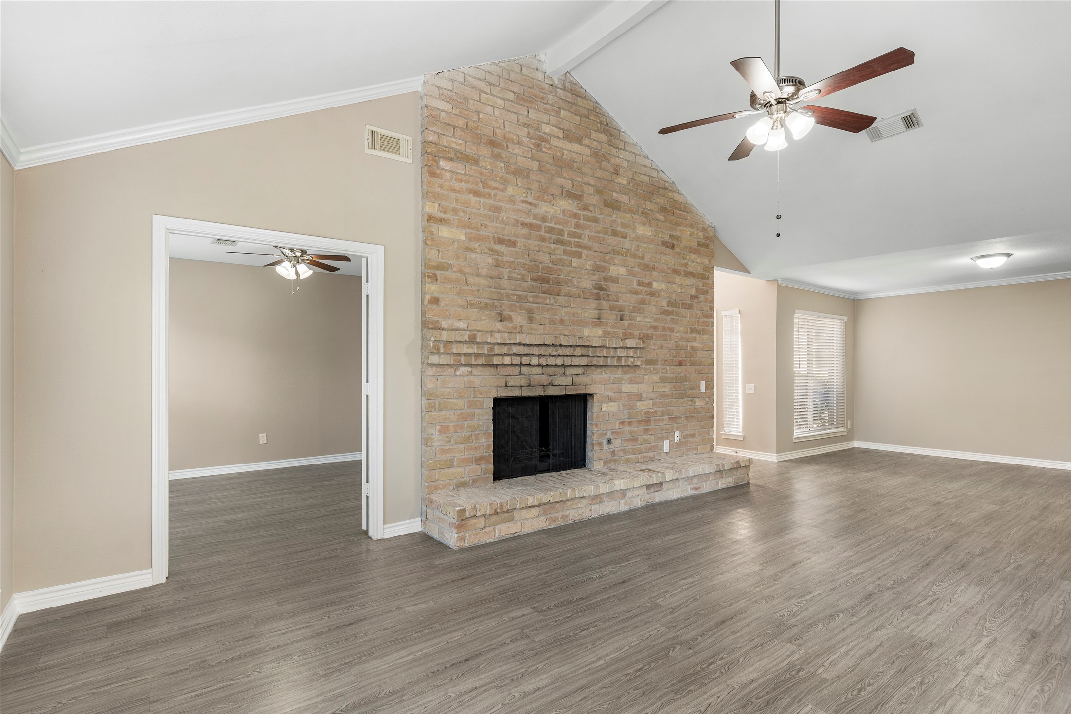 2007 Fernspray Lane Houston, TX 77084 - Photo 8 of 34 an empty room with wooden floor and a fireplace