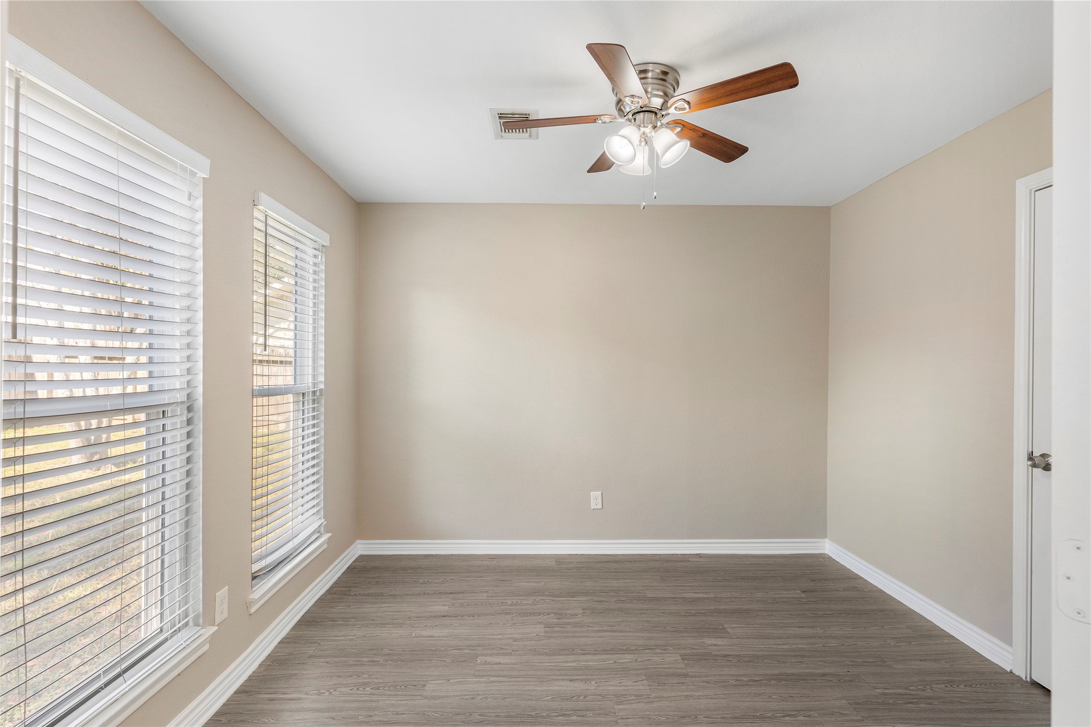 2007 Fernspray Lane Houston, TX 77084 - Photo 10 of 34 an empty room with wooden floor and windows