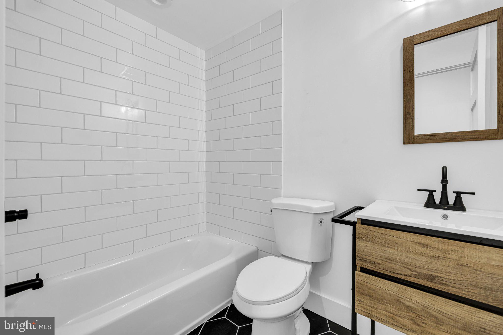 2801 Round Road Baltimore, MD 21225 - Photo 13 of 29 a bathroom with a sink a toilet and bathtub