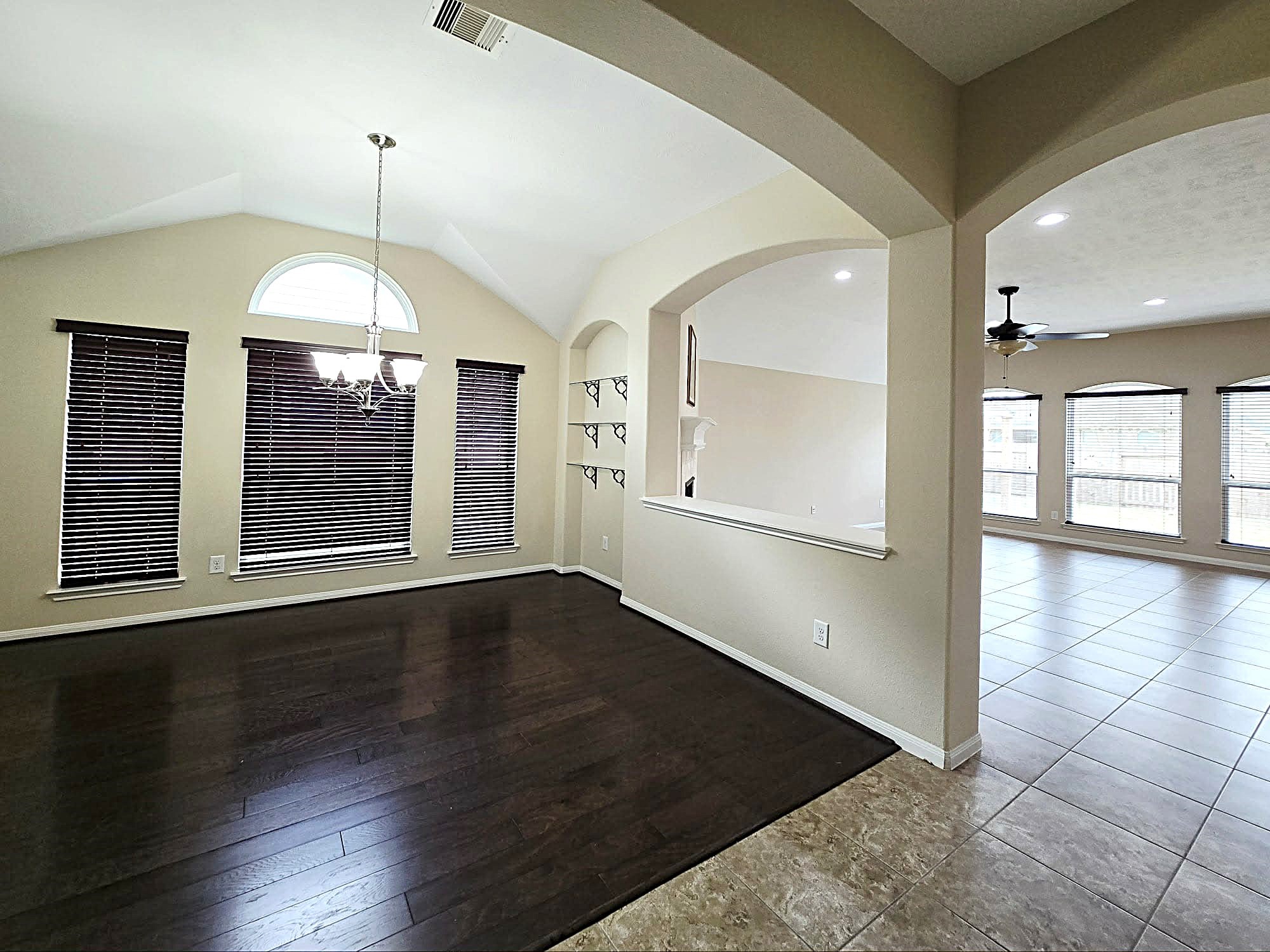 14015 Hailey Springs Lane Humble, TX 77396 - Photo 15 of 34 an empty room with wooden floor and windows