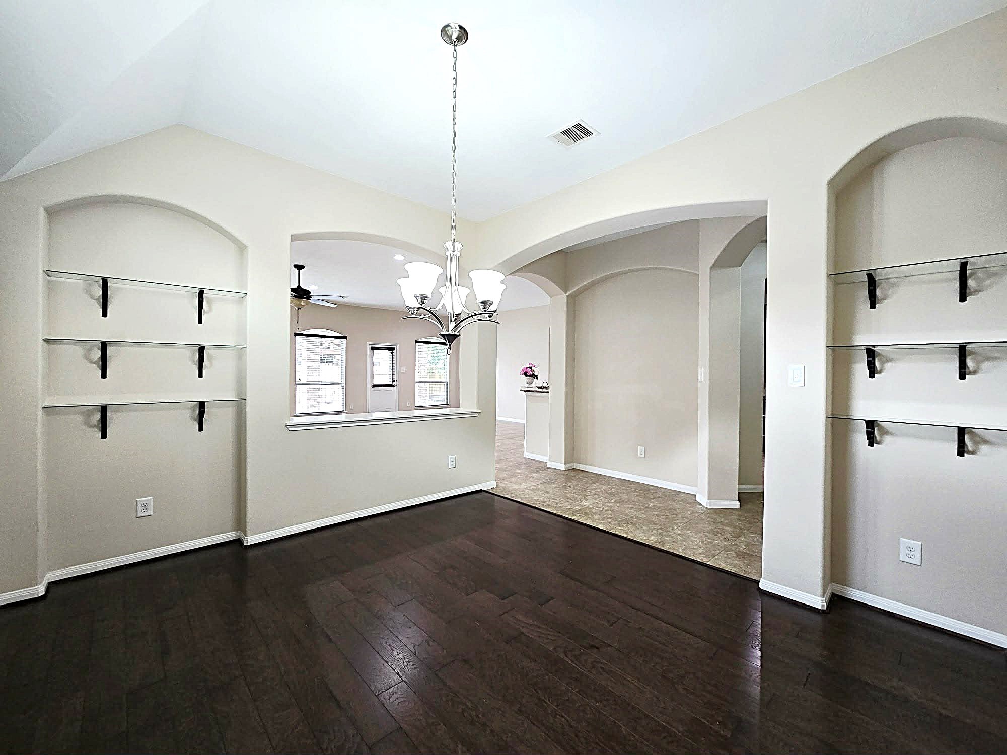 14015 Hailey Springs Lane Humble, TX 77396 - Photo 17 of 34 a view of a kitchen with wooden floor and a window