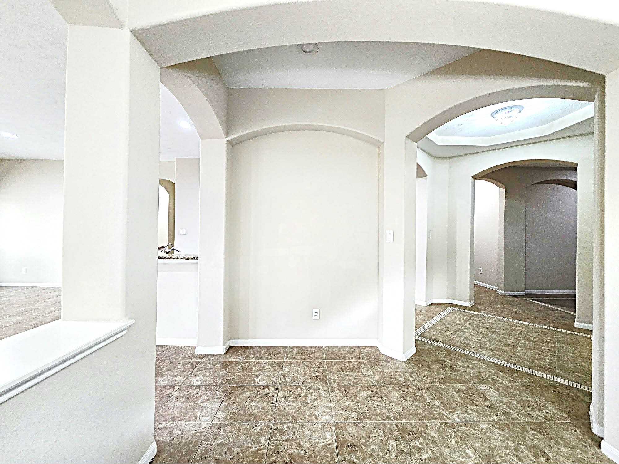 14015 Hailey Springs Lane Humble, TX 77396 - Photo 18 of 34 a view of a hallway with a glass door and a refrigerator