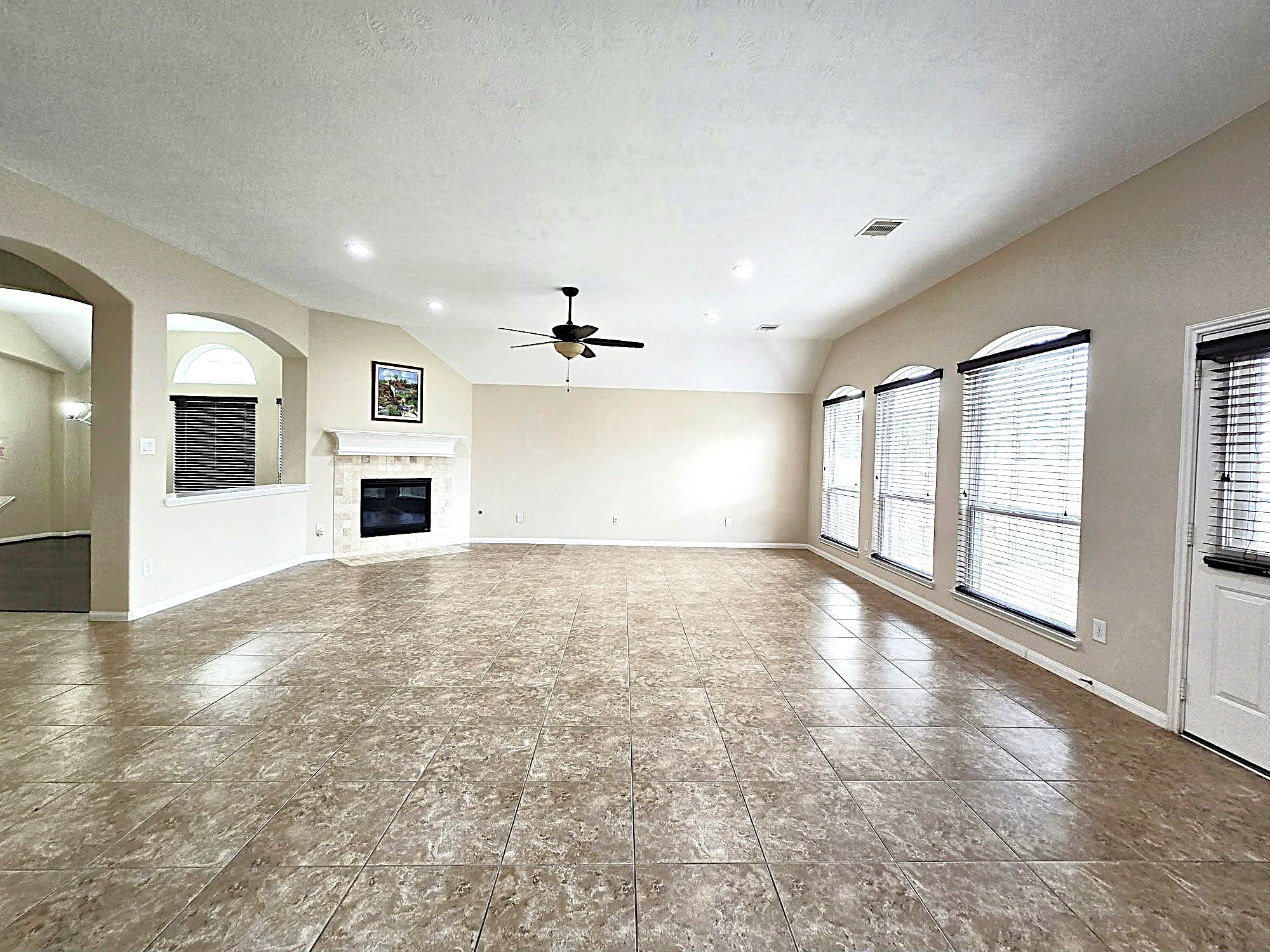 14015 Hailey Springs Lane Humble, TX 77396 - Photo 24 of 34 an empty room with windows and fireplace