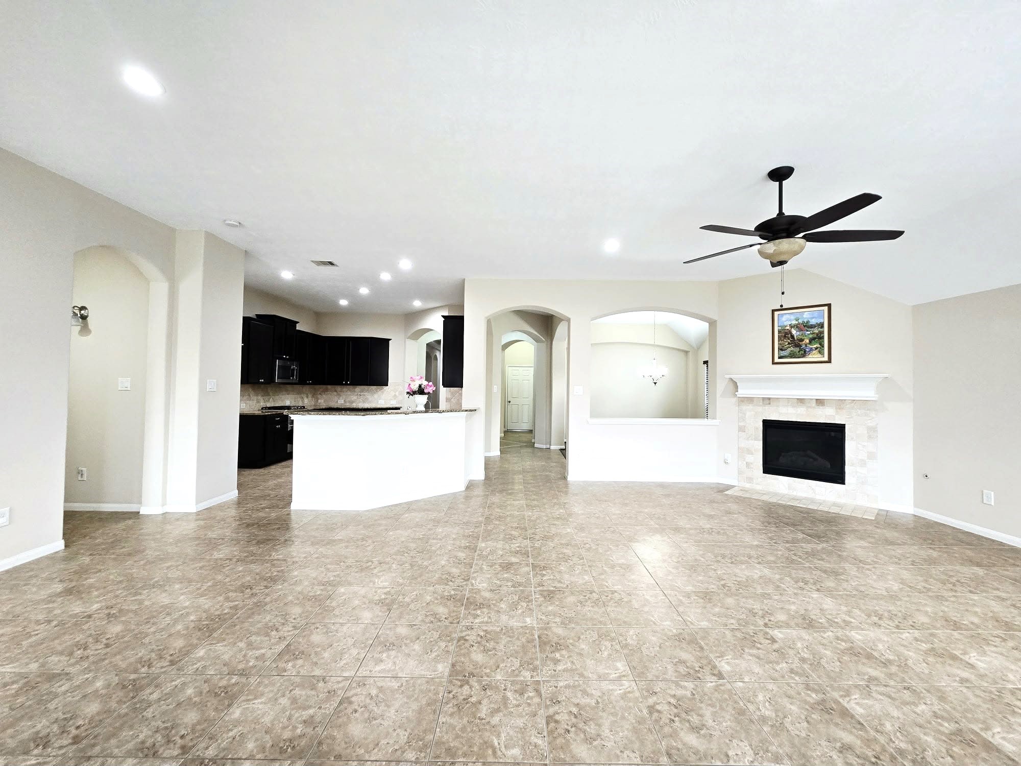 14015 Hailey Springs Lane Humble, TX 77396 - Photo 25 of 34 a view of a kitchen with a sink and a fireplace