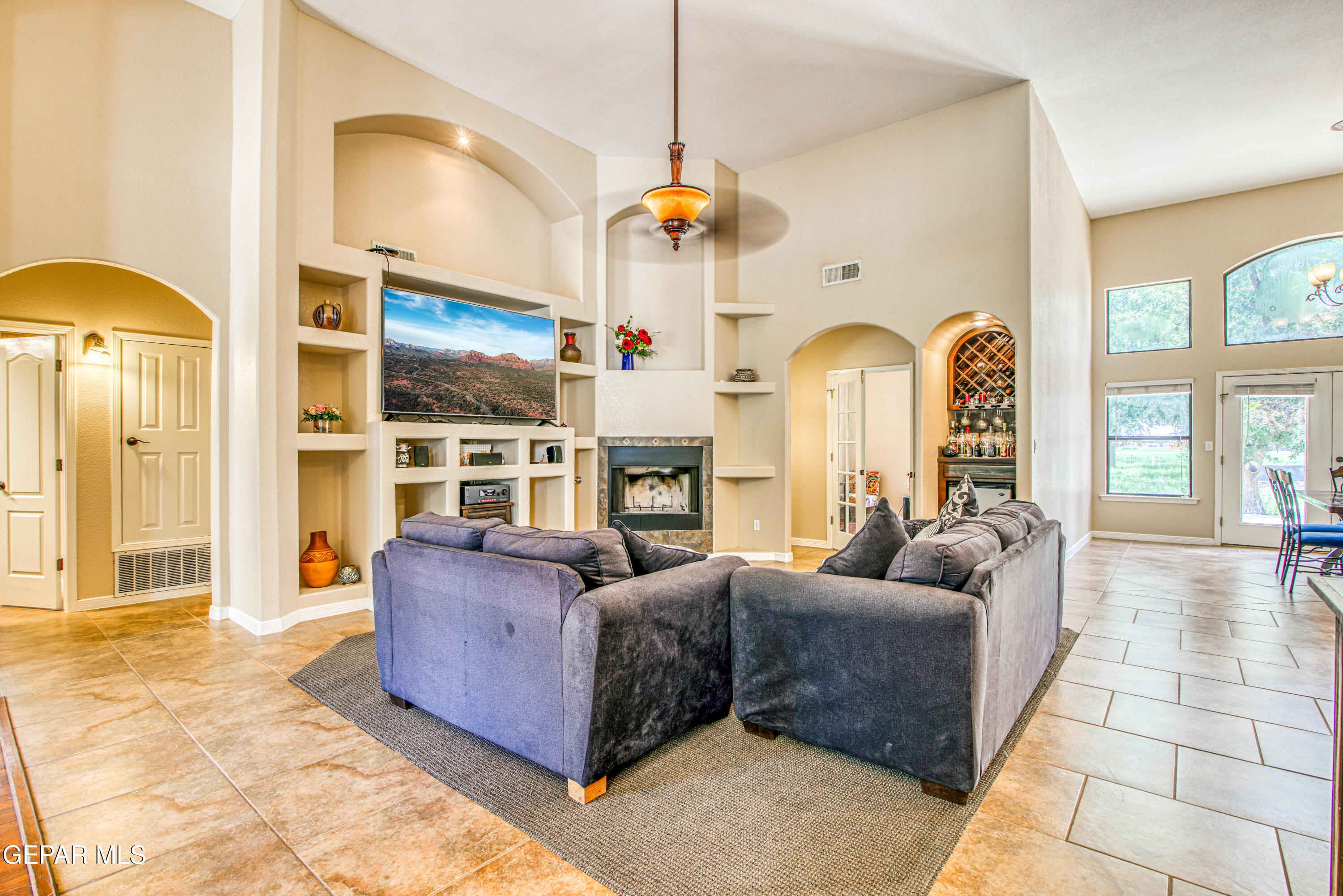 617 Wallace Road Anthony, NM 88021 - Photo 13 of 87 a living room with fireplace furniture and a chandelier