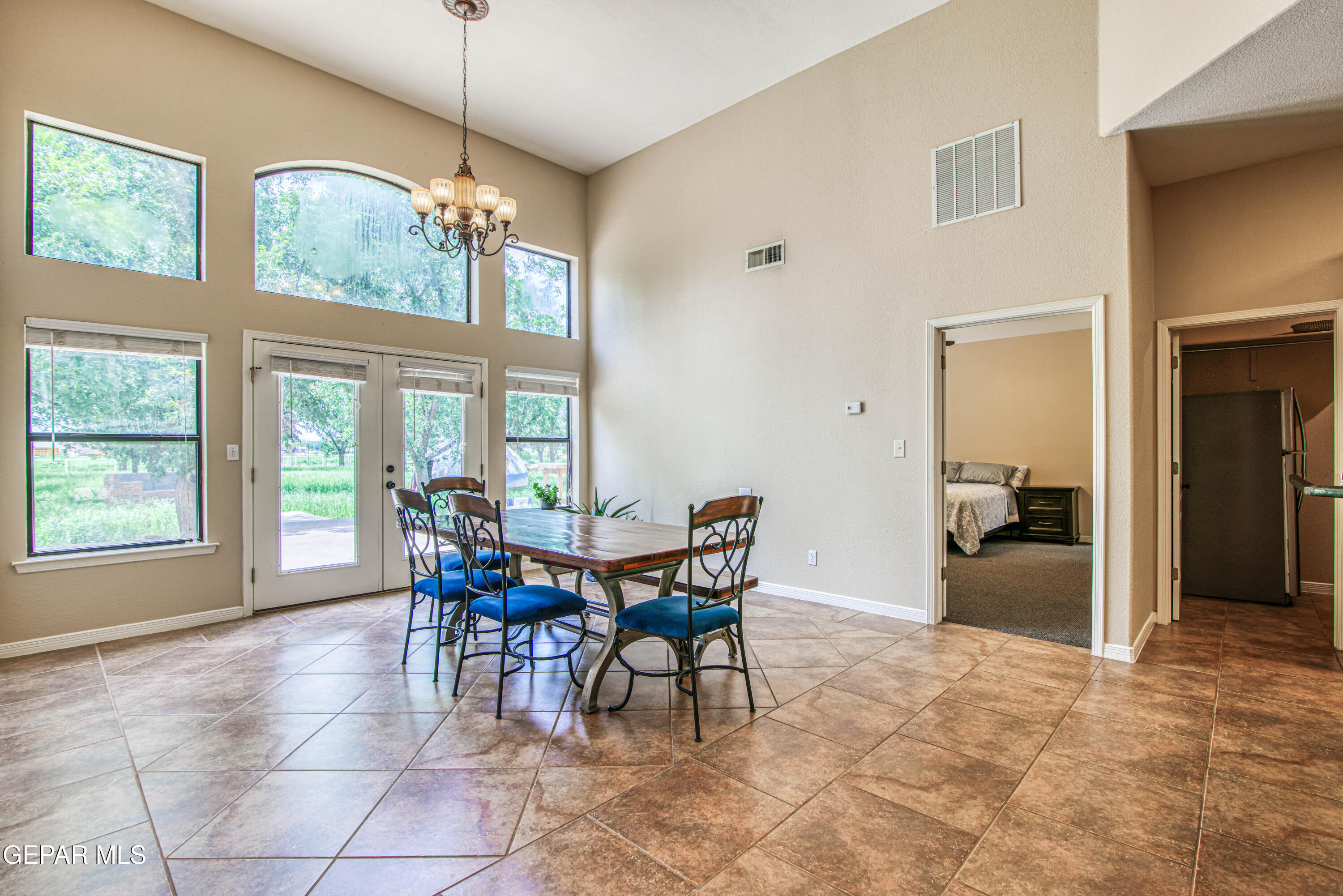 617 Wallace Road Anthony, NM 88021 - Photo 16 of 87 a dining room with furniture a chandelier and a rug