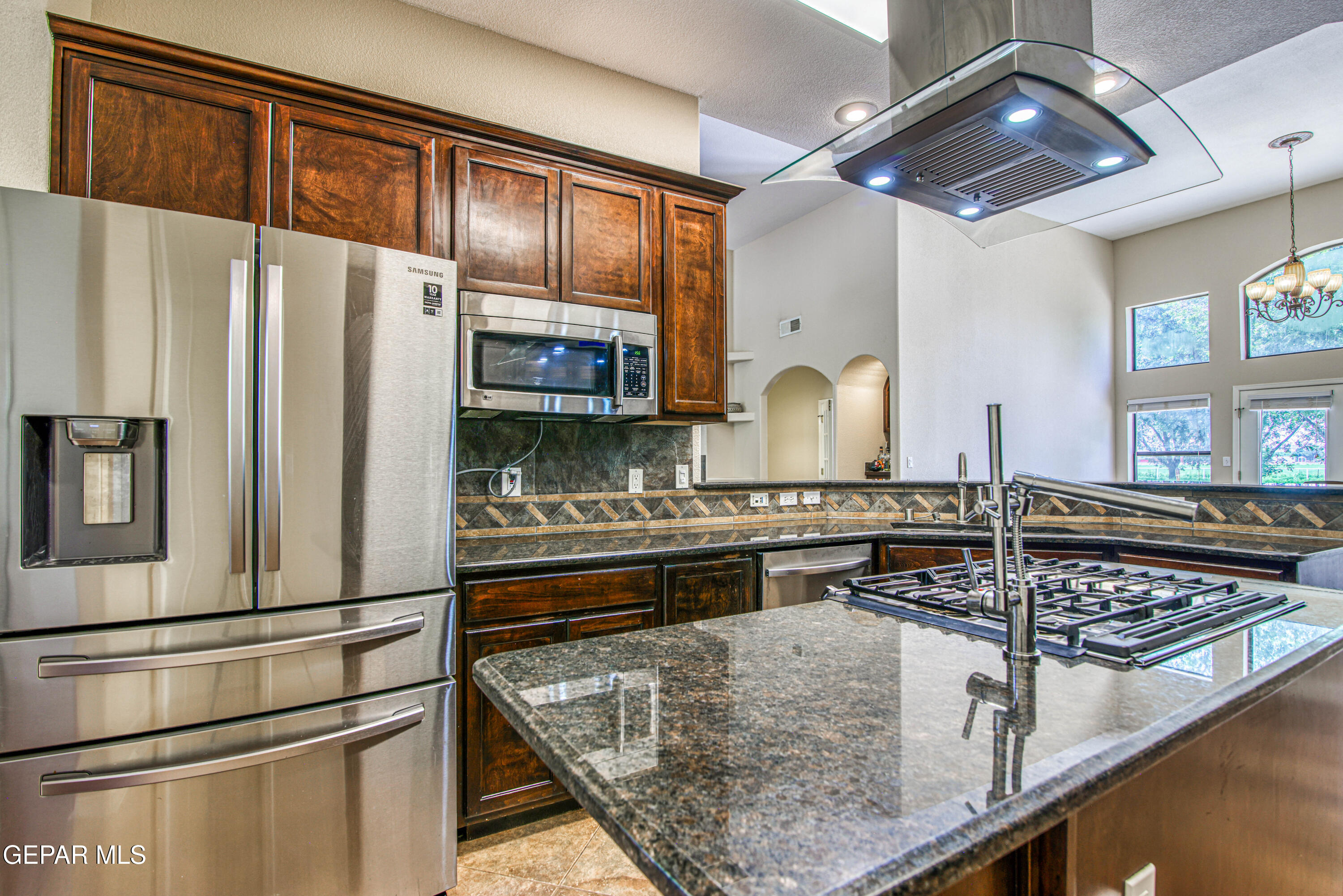 617 Wallace Road Anthony, NM 88021 - Photo 26 of 87 a kitchen with stainless steel appliances granite countertop a stove and a refrigerator