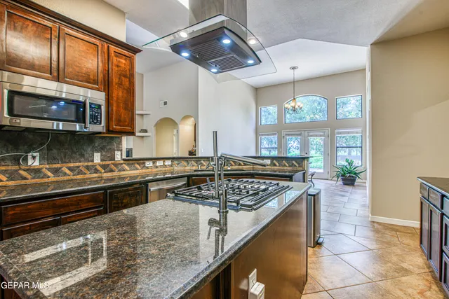 a spacious bedroom with a bed and a chandelier