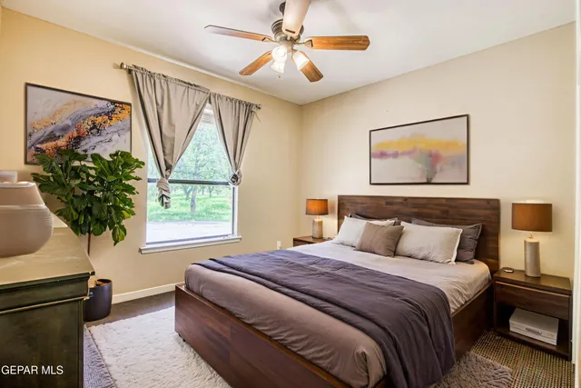 a bedroom with bed and a painting on the wall