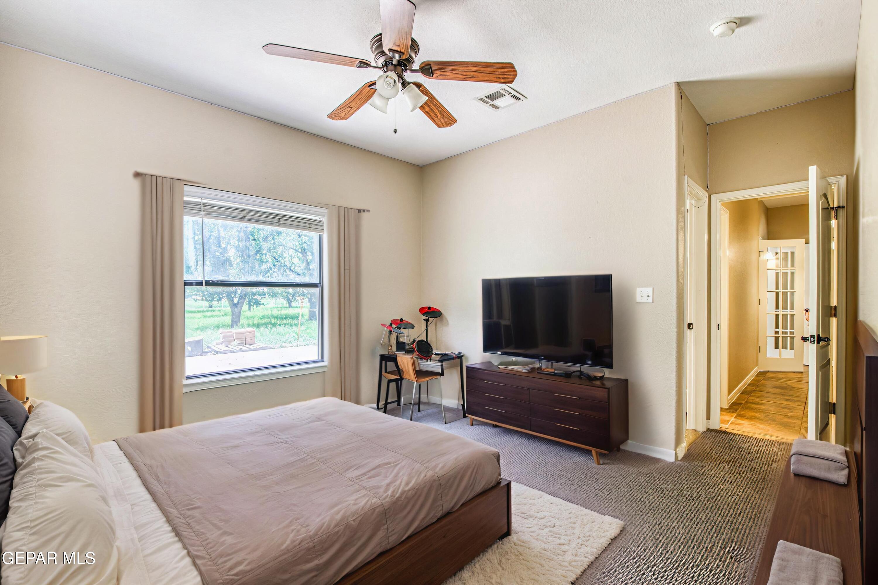 617 Wallace Road Anthony, NM 88021 - Photo 57 of 87 a bedroom with a bed and a flat screen tv