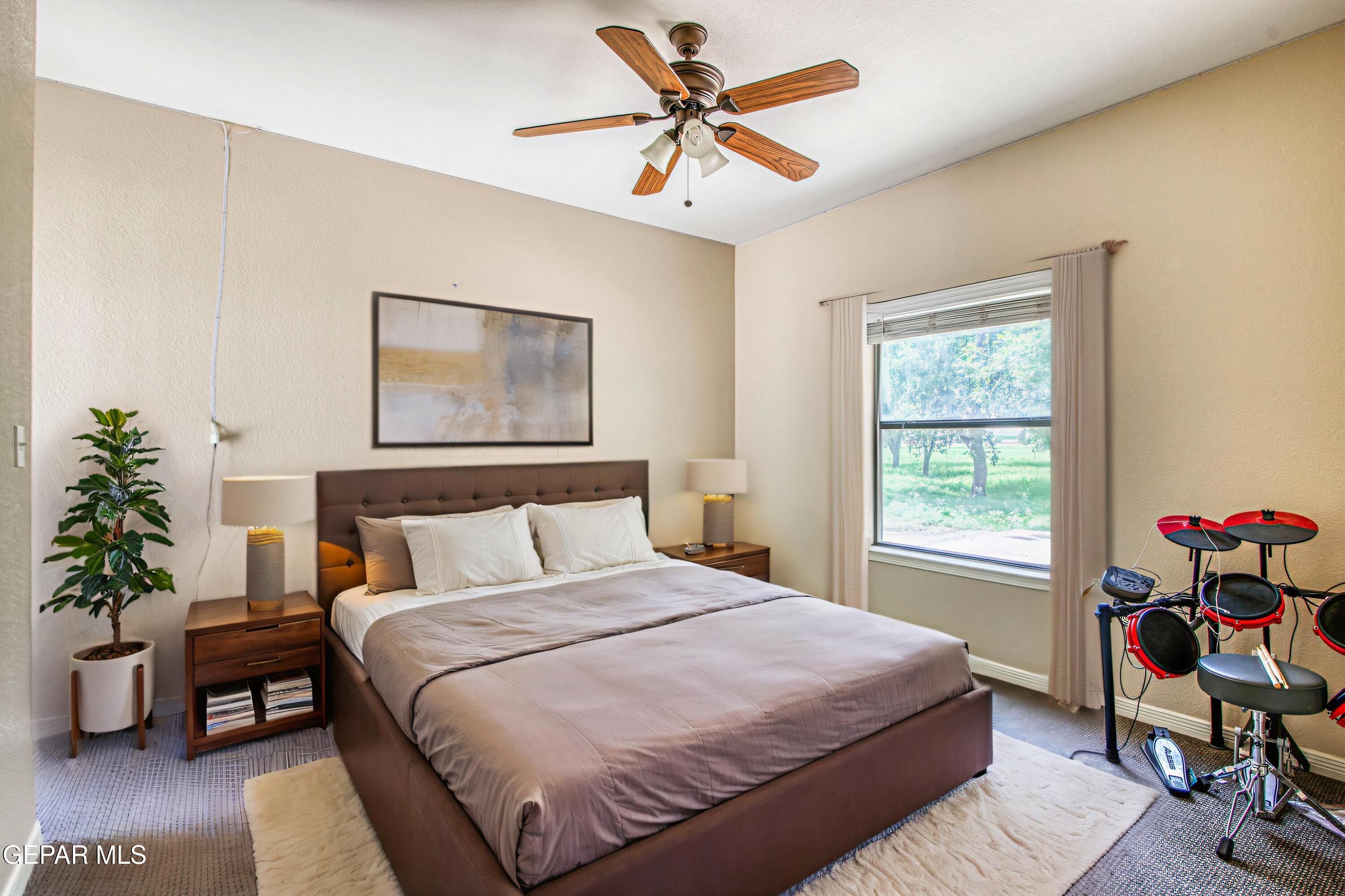 617 Wallace Road Anthony, NM 88021 - Photo 60 of 87 a bedroom with a bed and a chandelier