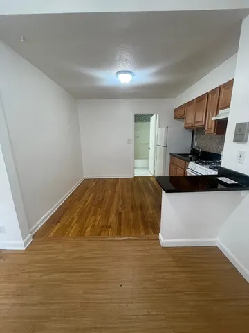 a bedroom with a bed and a night stand