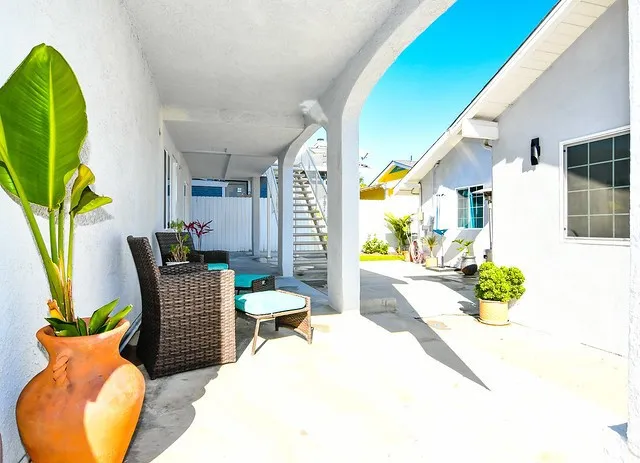 a balcony with table and chairs