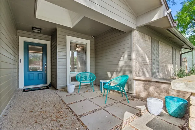 a view of two chairs in a patio