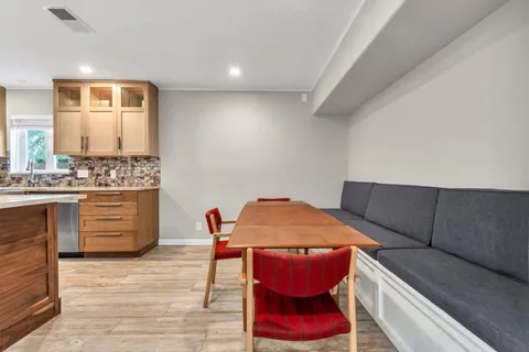 a dining room with furniture and wooden floor