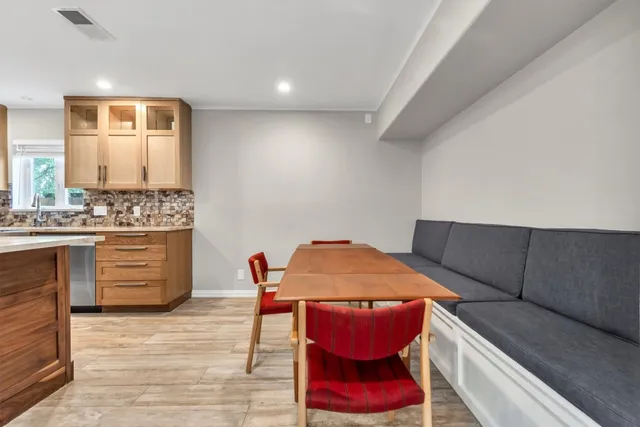 a dining room with furniture and wooden floor
