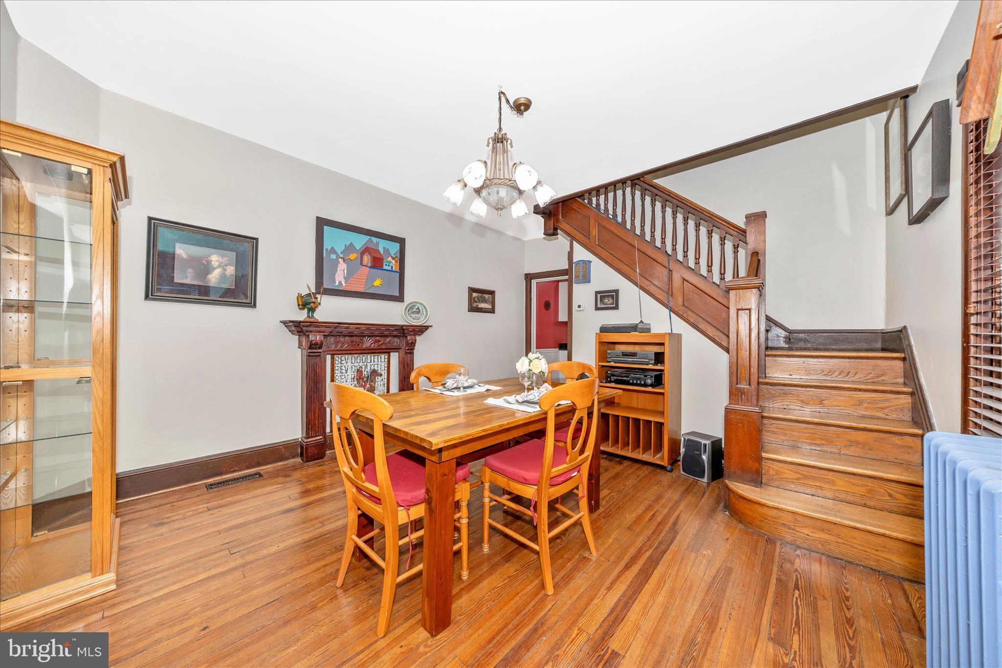 24 East 8th Street Frederick, MD 21701 - Photo 13 of 51 a dining room with wooden floor a chandelier a wooden table and chairs