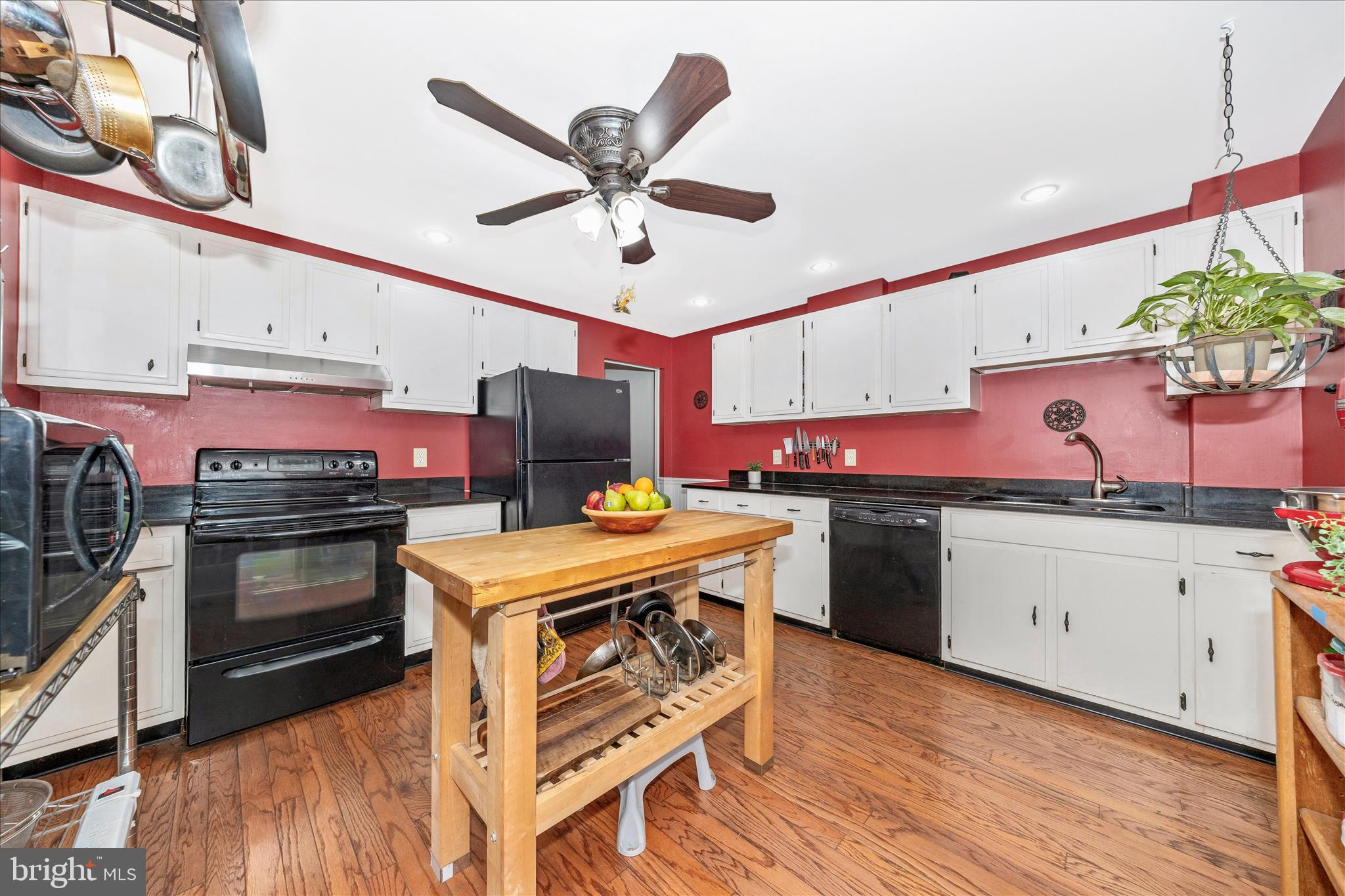 24 East 8th Street Frederick, MD 21701 - Photo 17 of 51 a kitchen with a stove cabinets and wooden floor