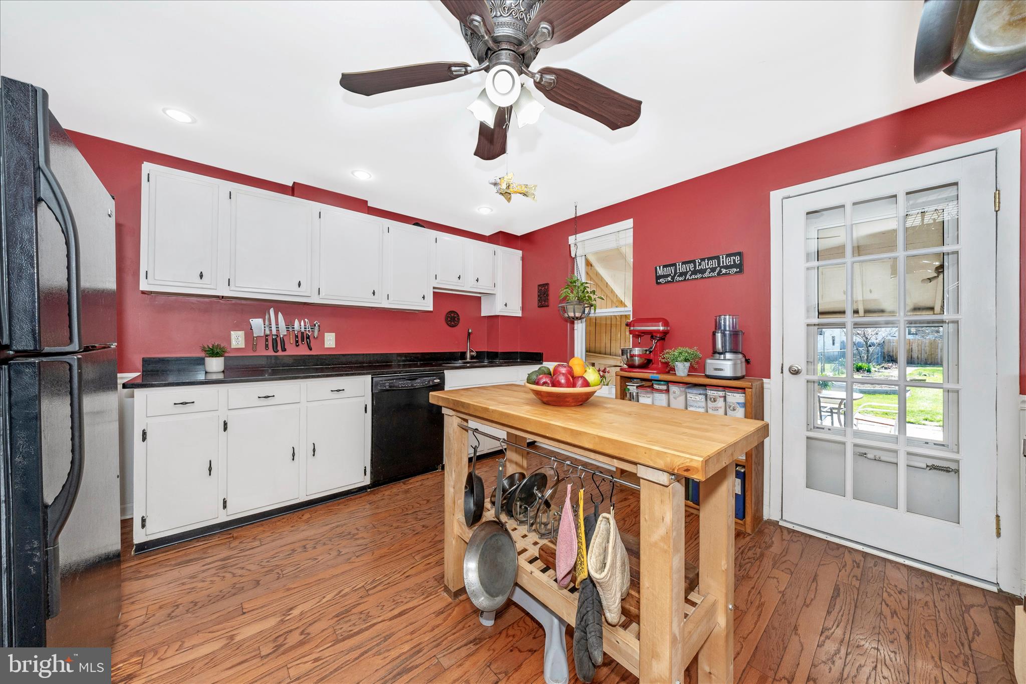 24 East 8th Street Frederick, MD 21701 - Photo 18 of 51 a kitchen with a stove a refrigerator and a dining table