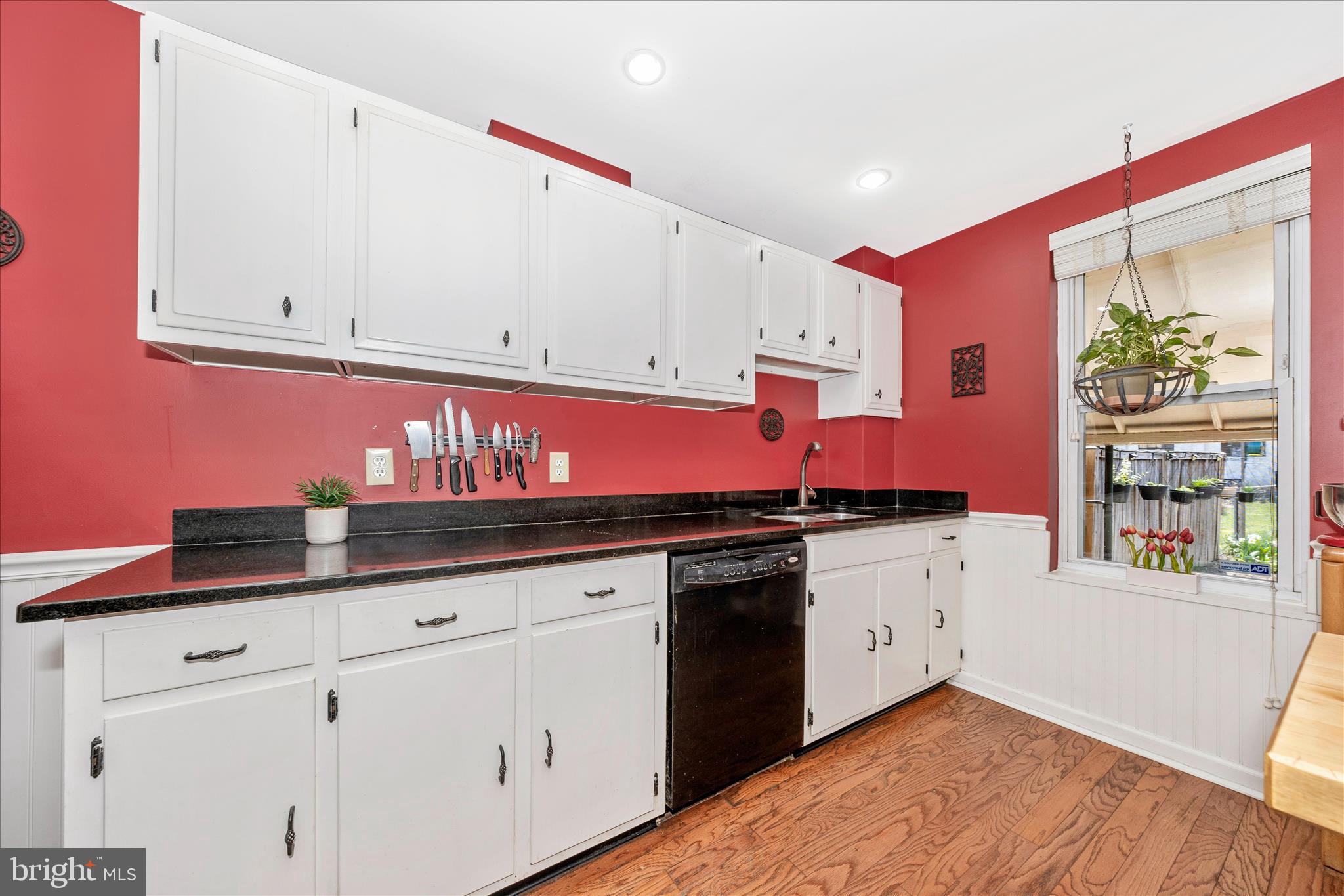 24 East 8th Street Frederick, MD 21701 - Photo 19 of 51 a kitchen with granite countertop a sink a stove and cabinets
