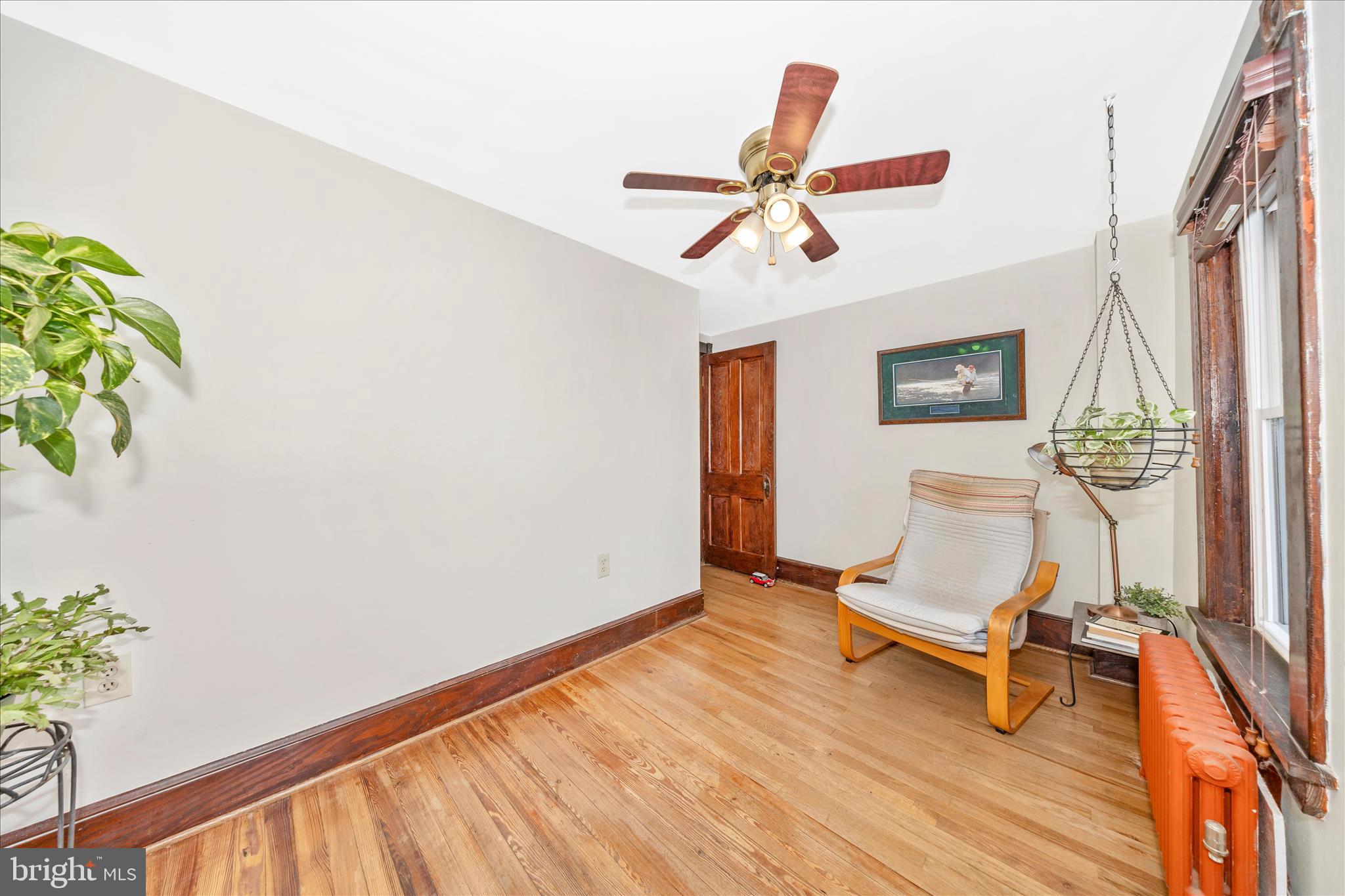 24 East 8th Street Frederick, MD 21701 - Photo 33 of 51 a view of a livingroom with wooden floor and a ceiling fan