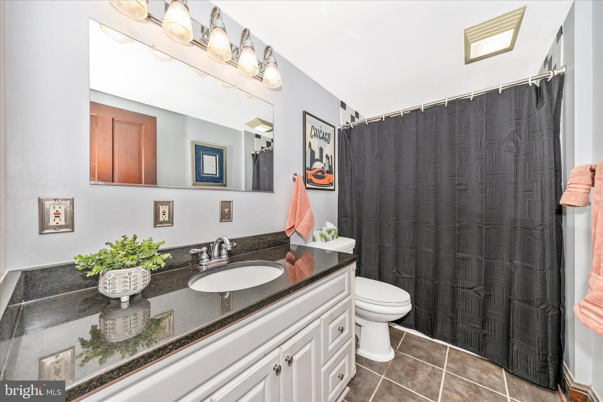 24 East 8th Street Frederick, MD 21701 - Photo 36 of 51 a bathroom with a granite countertop sink a toilet and mirror