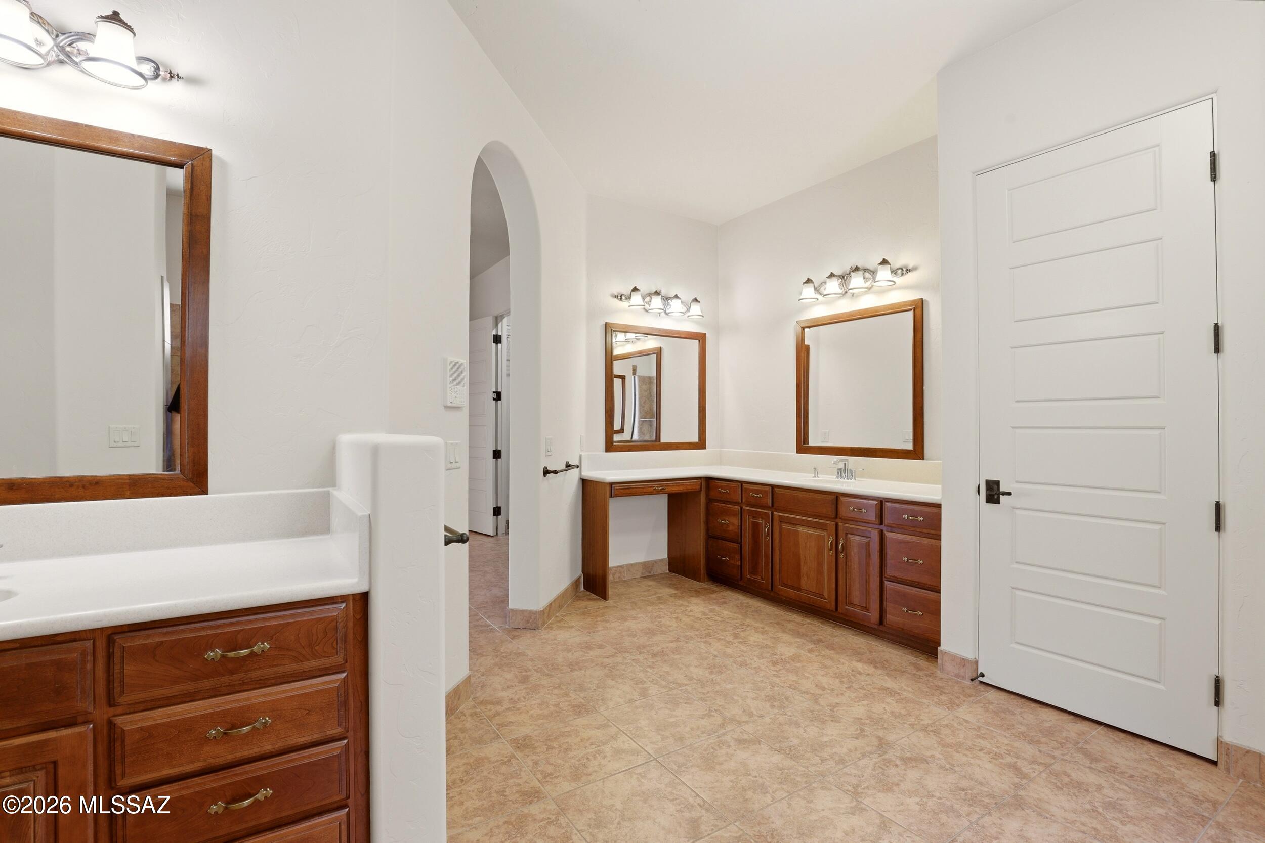 6331 West Trails End Road Tucson, AZ 85745 - Photo 14 of 41 a spacious bathroom with a granite countertop sink mirror and a bathtub