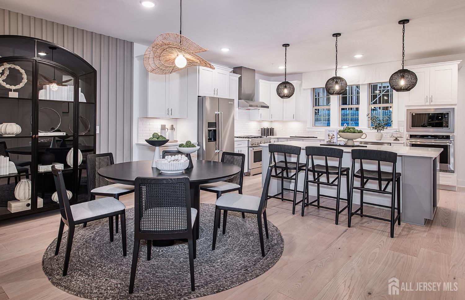 a large kitchen with a table and chairs