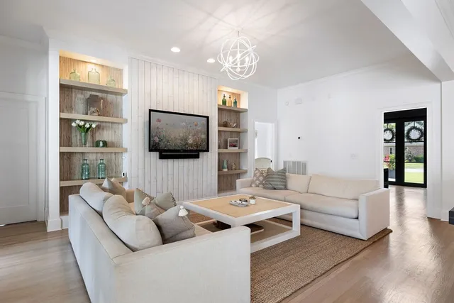 a kitchen with stainless steel appliances granite countertop a stove a refrigerator a dining table and chairs with wooden floor